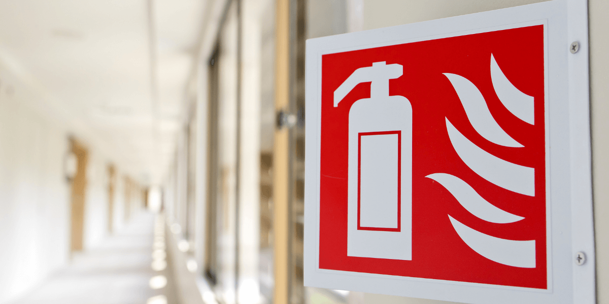 Fire extinguisher signage on a building wall